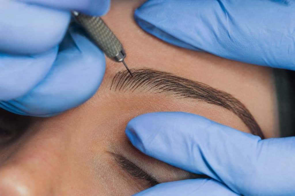 Close-up of an eyebrow during a micropigmentation session